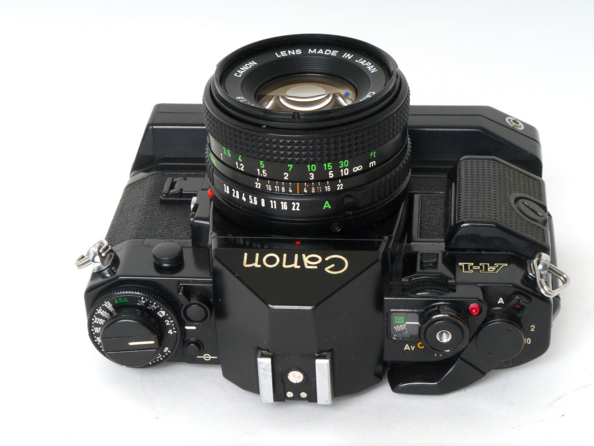 Canon A-1 Gehäuse mit FD 1,8/50mm und Power Winder A2 – Sehr gut