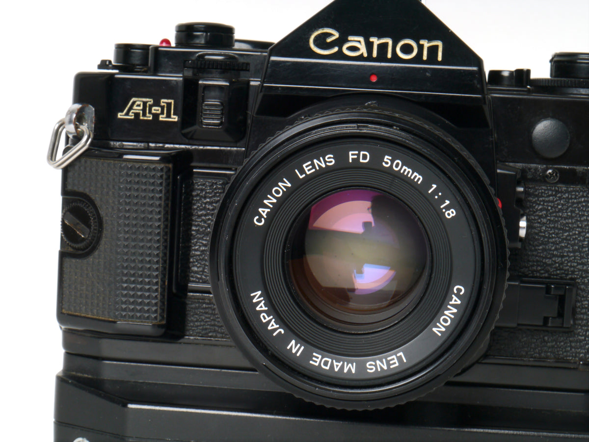 Canon A-1 Gehäuse mit FD 1,8/50mm und Power Winder A2 – Sehr gut