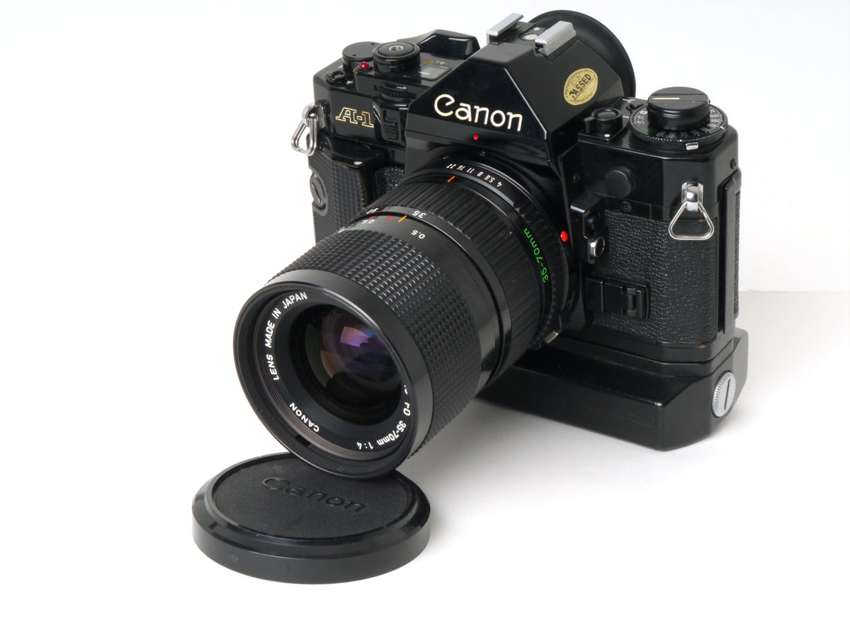 Canon A-1 Gehäuse mit FD 4/35-70mm und Power Winder A2 – Gut