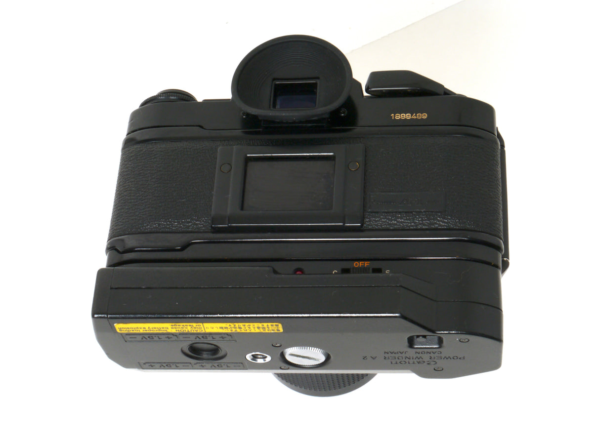 Canon A-1 Gehäuse mit FD 4/35-70mm und Power Winder A2 – Gut
